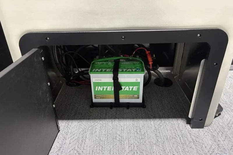 Slide: The Image of 2026 Sun Tracker Fishin' Barge 22 DLX pontoon boat interior with spacious seating in showroom. - 36