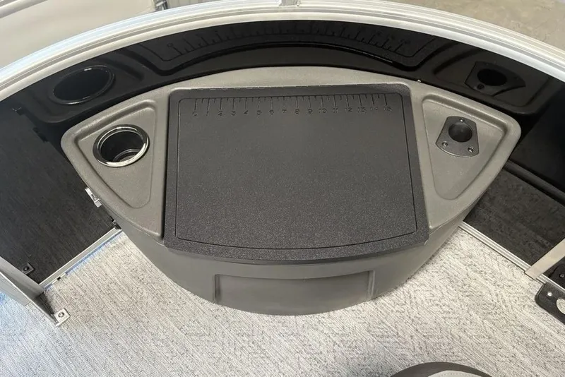 Slide: The Image of 2026 Sun Tracker Fishin' Barge 22 DLX pontoon boat in showroom on trailer. - 4