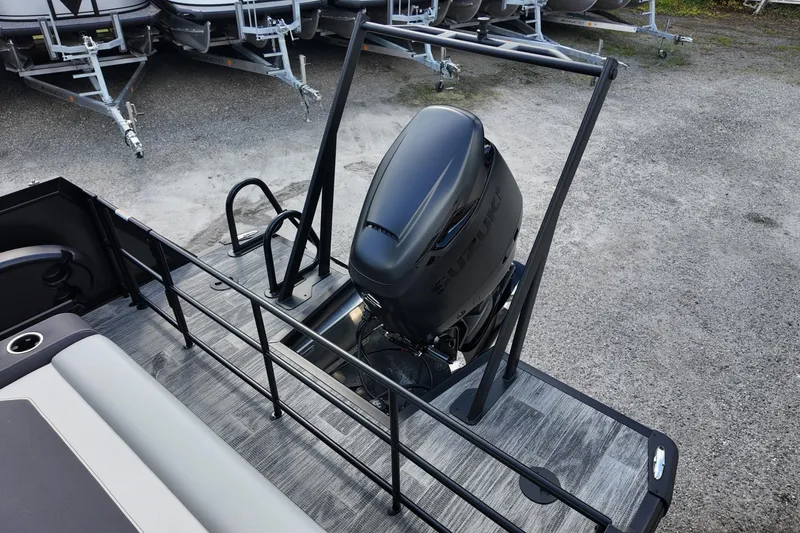 Slide: The Image of Viaggio Diamante 24S 2026 boat with Suzuki outboard motor, docked on gravel surface. - 15