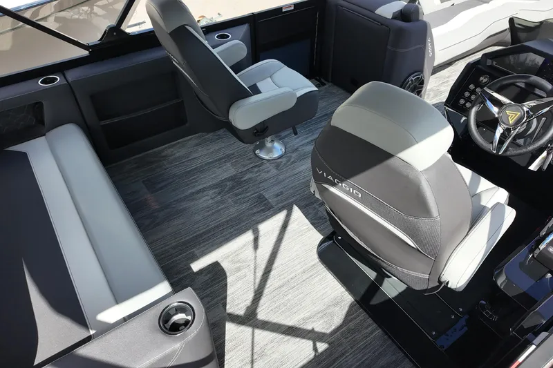 Slide: The Image of 2026 Viaggio Diamante 24S boat interior with modern seating and sleek steering wheel design. - 8