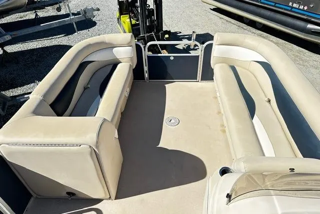 Slide: The Image of 2016 Godfrey Sweetwater 2286 Pontoon interior with beige seating and spacious layout. - 11