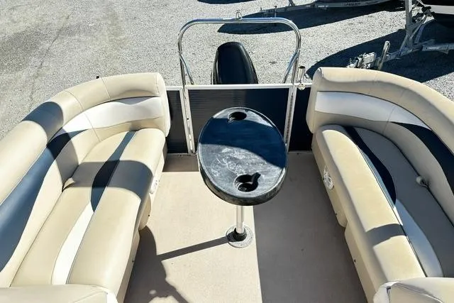 Slide: The Image of 2016 Godfrey Sweetwater 2286 Pontoon interior with beige seating and central table. - 14