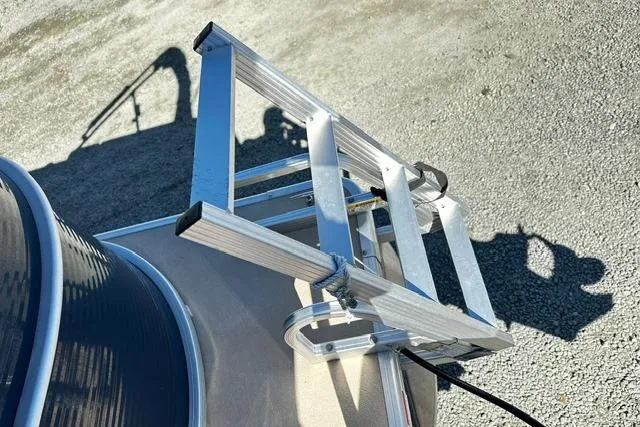 Slide: The Image of Aluminum ladder on 2016 Godfrey Sweetwater 2286 Pontoon, resting on gravel surface. - 15
