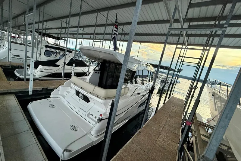 Slide: The Image of 2018 Regal 42 Grande Coupe yacht docked on turquoise water. - 1