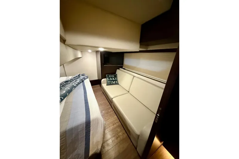 Slide: The Image of Luxurious bedroom interior of 2018 Regal 42 Grande Coupe yacht with nautical-themed bedding. - 13