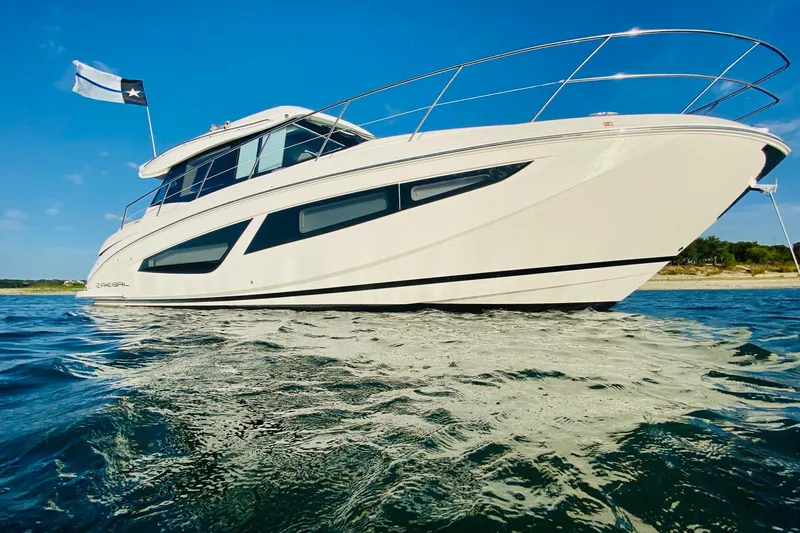 Slide: The Image of Luxurious bedroom interior of 2018 Regal 42 Grande Coupe yacht, featuring elegant bedding and ambient lighting. - 17