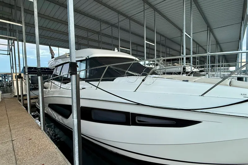 Slide: The Image of 2018 Regal 42 Grande Coupe yacht docked in a covered marina. - 20