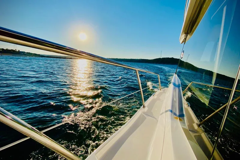 Slide: The Image of 2018 Regal 42 Grande Coupe cruising on sunny waters, reflecting sunlight. - 30