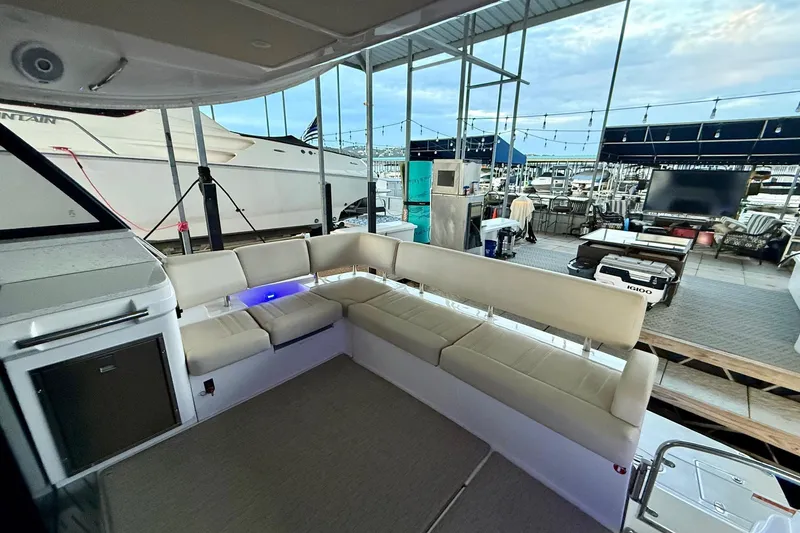 Slide: The Image of 2018 Regal 42 Grande Coupe docked in a marina with covered roof and flags. - 4