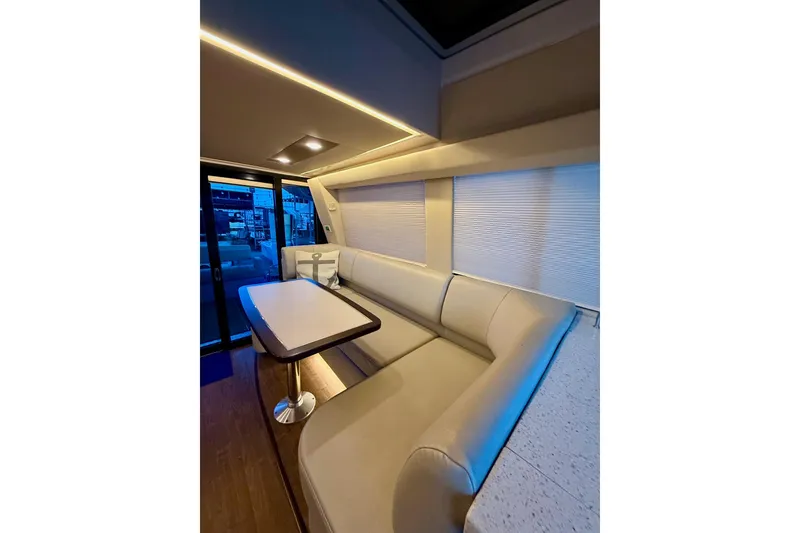 Slide: The Image of Luxurious interior of 2018 Regal 42 Grande Coupe yacht with elegant seating and ambient lighting. - 8