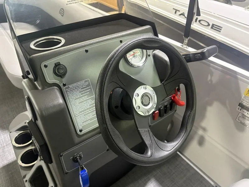 Slide: The Image of Steering console of 2026 Sun Tracker PARTY BARGE® 16 DLX with cup holder and controls. - 7