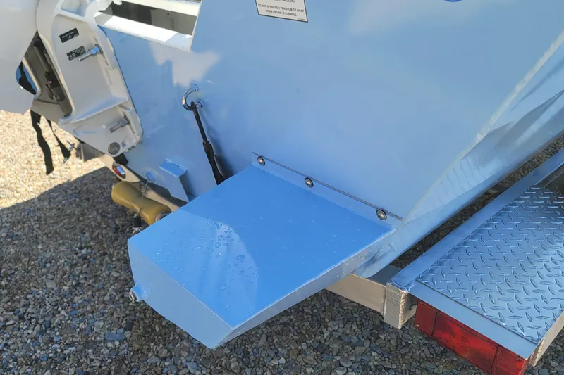 Slide: The Image of Rear view of a 2026 G3 Bay 20 boat with a blue platform and trailer. - 16