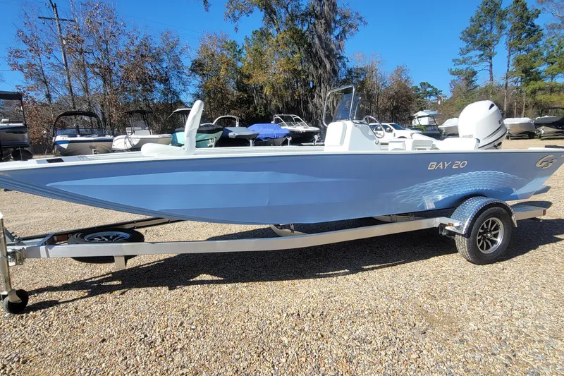 Slide: The Image of 2026 G3 Bay 20 boat on trailer, light blue, parked outdoors. - 19