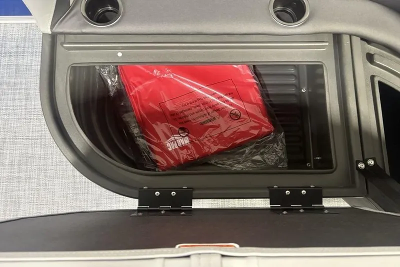 Slide: The Image of Storage compartment in 2026 Sun Tracker Party Barge 16 DLX with red life jacket. - 13