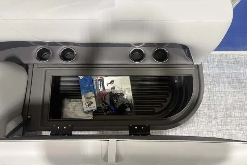 Slide: The Image of Storage compartment in 2026 Sun Tracker Party Barge 16 DLX with cup holders and accessories. - 14