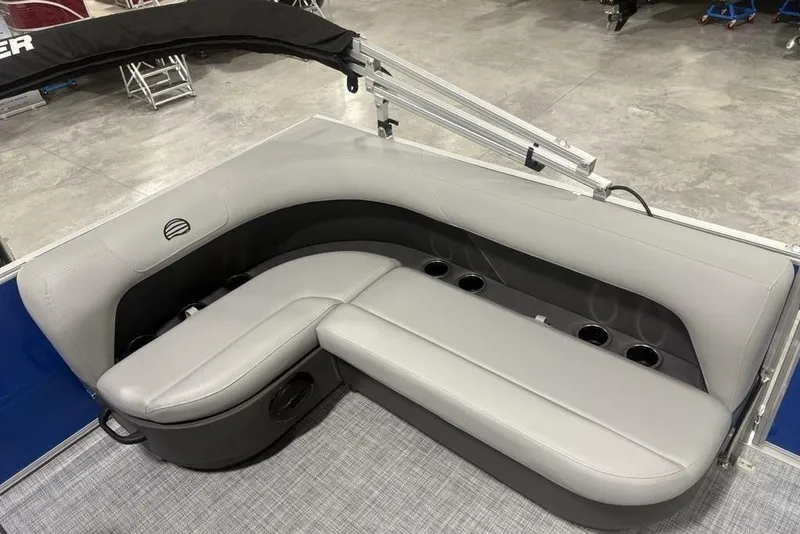 Slide: The Image of 2026 Sun Tracker Party Barge 16 DLX interior seating with cup holders. - 17