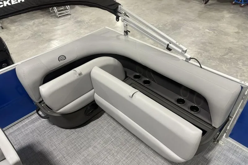 Slide: The Image of 2026 Sun Tracker Party Barge 16 DLX interior seating with cup holders and storage. - 19