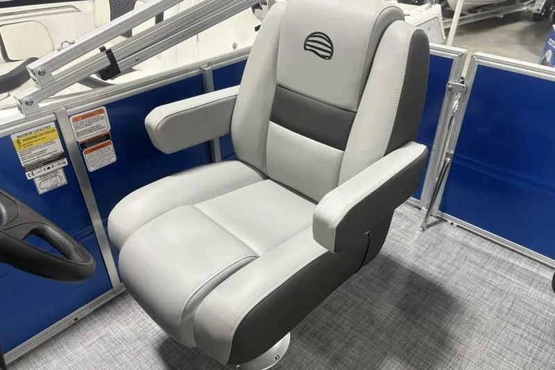 Slide: The Image of 2026 Sun Tracker Party Barge 16 DLX captain's chair, gray upholstery, blue panel background. - 20