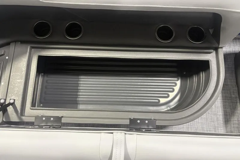 Slide: The Image of Interior storage compartment of 2026 Sun Tracker Party Barge 16 DLX with cup holders. - 5