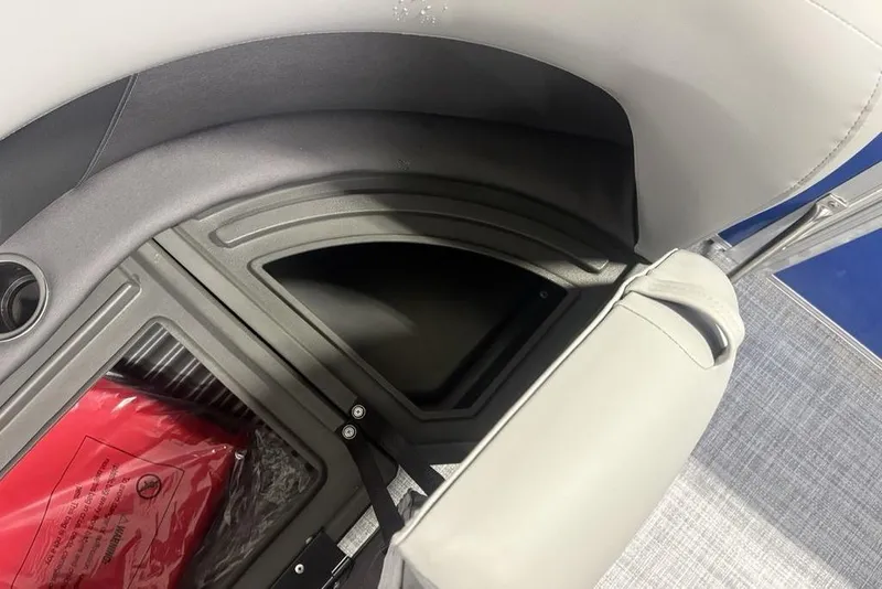 Slide: The Image of Storage compartment in 2026 Sun Tracker Party Barge 16 DLX with red life jacket. - 8