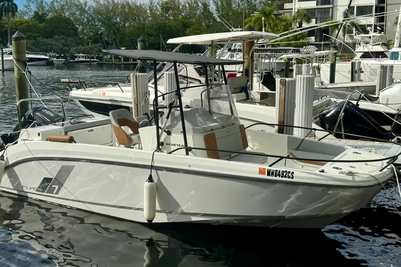 Slide: The Image of 2024 Beneteau Flyer 7 SPACEdeck boat docked in a marina, side view. - 1