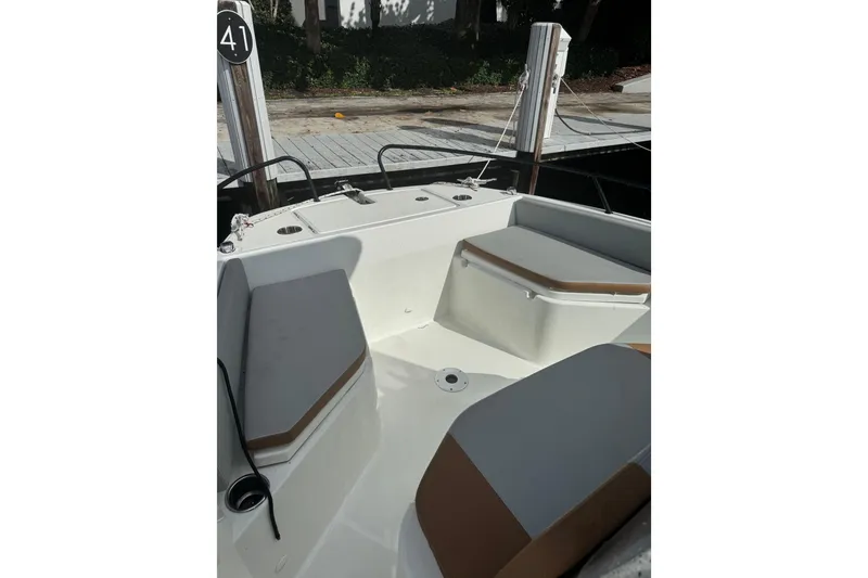 Slide: The Image of 2024 Beneteau Flyer 7 SPACEdeck interior with cushioned seating and sleek design. - 13
