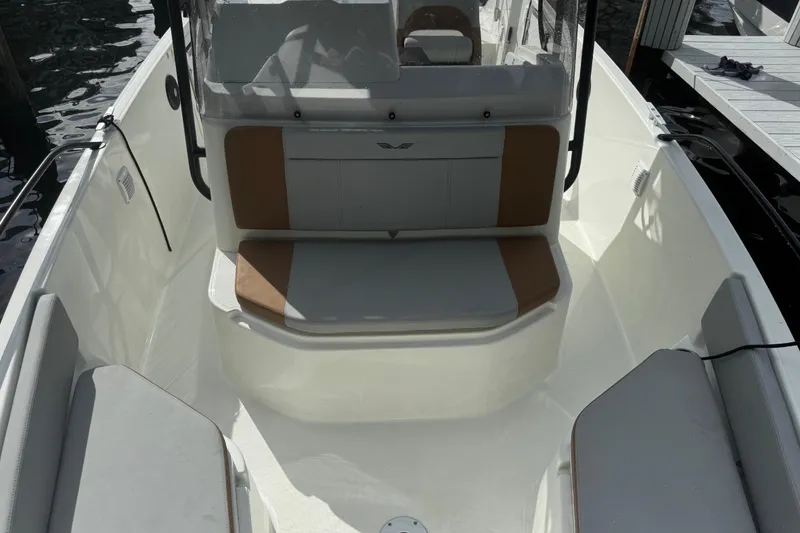Slide: The Image of 2024 Beneteau Flyer 7 SPACEdeck interior with seating and console, docked by water. - 14