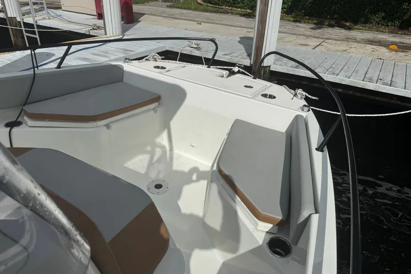 Slide: The Image of 2024 Beneteau Flyer 7 SPACEdeck boat interior with cushioned seating and dock view. - 16