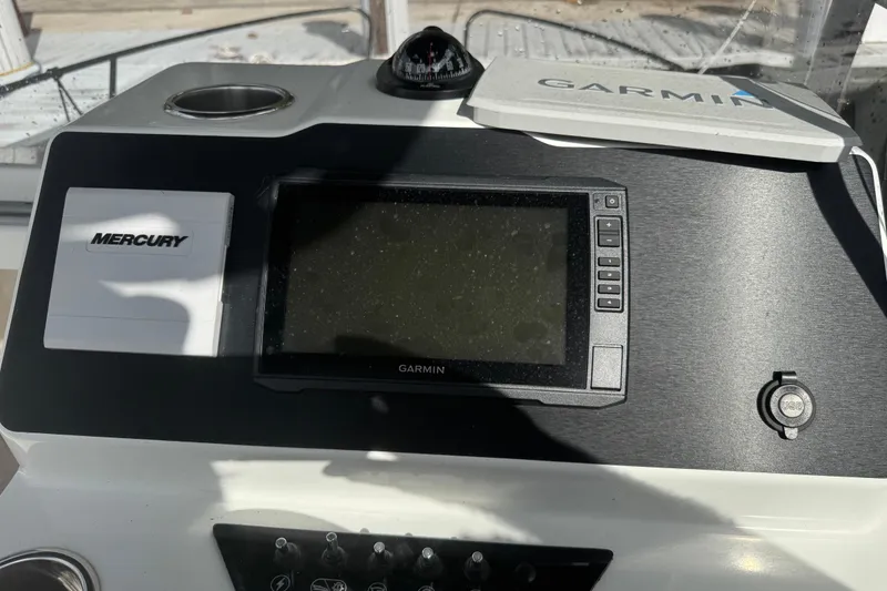 Slide: The Image of 2024 Beneteau Flyer 7 SPACEdeck dashboard with Garmin and Mercury controls. - 17