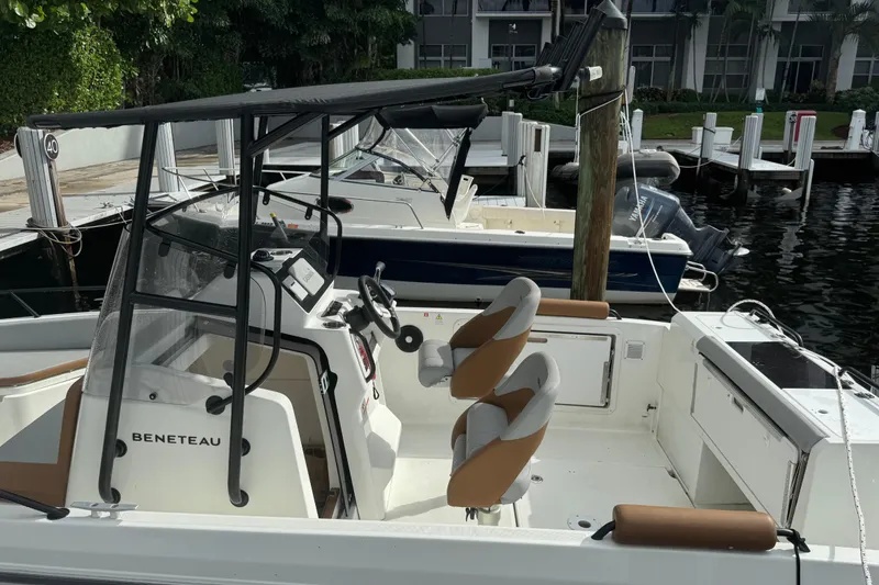 Slide: The Image of 2024 Beneteau Flyer 7 SPACEdeck boat docked, featuring modern seating and steering console. - 20