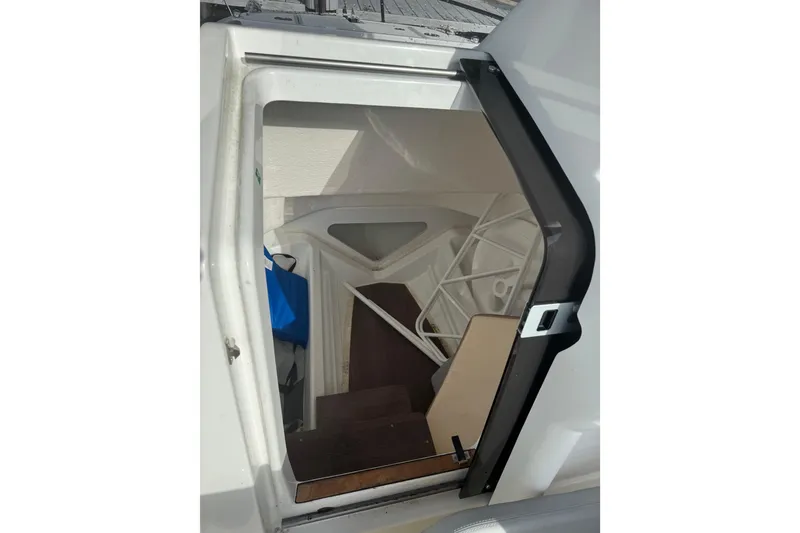 Slide: The Image of 2024 Beneteau Flyer 7 SPACEdeck cabin interior with open door and visible stairs. - 21