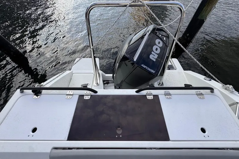 Slide: The Image of 2024 Beneteau Flyer 7 SPACEdeck with Mercury outboard motor, docked on calm water. - 31