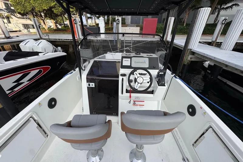 Slide: The Image of 2024 Beneteau Flyer 7 SPACEdeck cockpit with Garmin navigation, dual seats, and modern controls. - 33