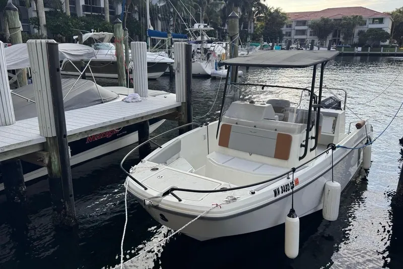 Slide: The Image of 2024 Beneteau Flyer 7 SPACEdeck boat docked at marina, featuring sleek design and canopy. - 35