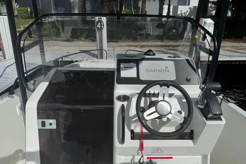Slide: The Image of 2024 Beneteau Flyer 7 SPACEdeck helm with Garmin navigation system and steering wheel. - 6
