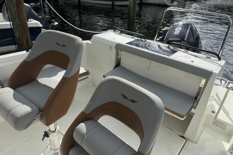 Slide: The Image of 2024 Beneteau Flyer 7 SPACEdeck boat interior with seating and motor view. - 7