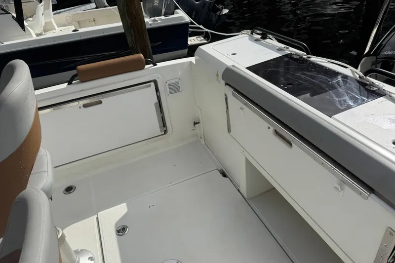 Slide: The Image of 2024 Beneteau Flyer 7 SPACEdeck interior with seating and storage compartments. - 9