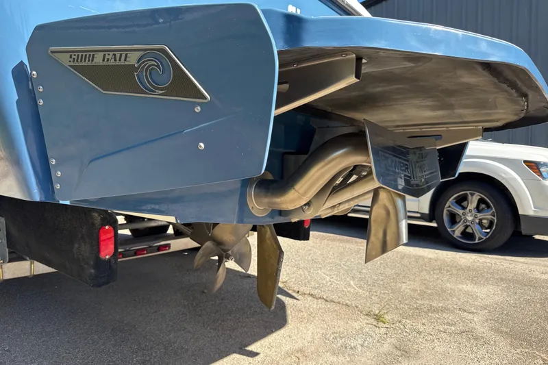 Slide: The Image of 2023 Axis T220 boat on trailer, blue and white design, parked outdoors. - 26