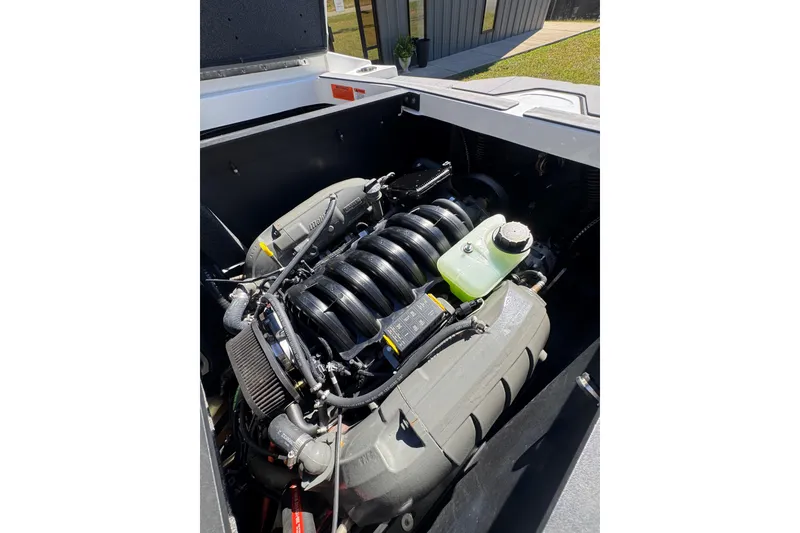 Slide: The Image of 2023 Axis T220 boat engine compartment with visible engine components. - 33