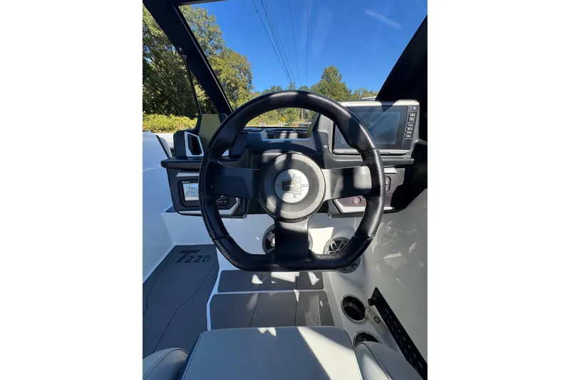 Slide: The Image of 2023 Axis T220 engine compartment with visible components and wiring. - 34