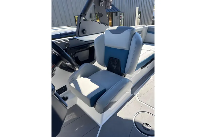 Slide: The Image of 2023 Axis T220 boat interior with seating and canopy under clear blue sky. - 8