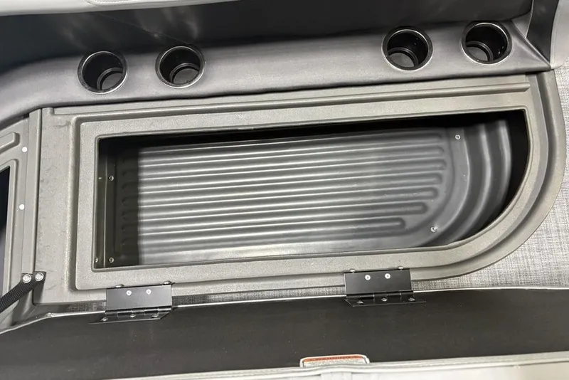 Slide: The Image of Sun Tracker Party Barge 16 DLX 2026 storage compartment with cup holders. - 10