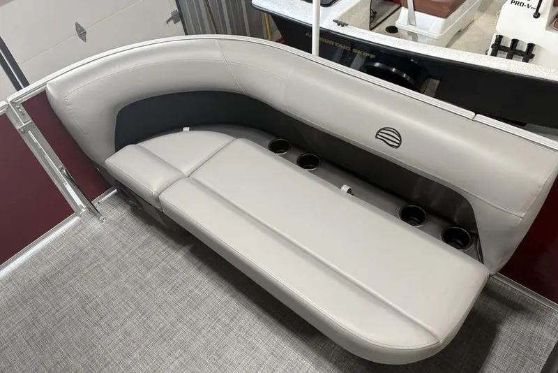 Slide: The Image of 2026 Sun Tracker Party Barge 16 DLX interior with gray seating and cup holders. - 11