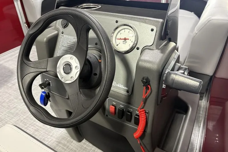 Slide: The Image of Steering console of 2026 Sun Tracker Party Barge 16 DLX with RPM gauge and controls. - 15