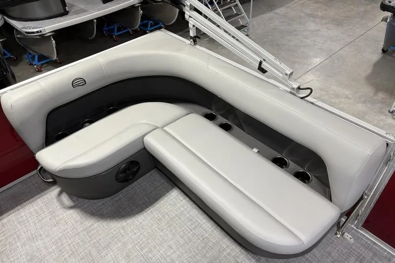 Slide: The Image of 2026 Sun Tracker Party Barge 16 DLX interior seating with cup holders and modern design. - 18