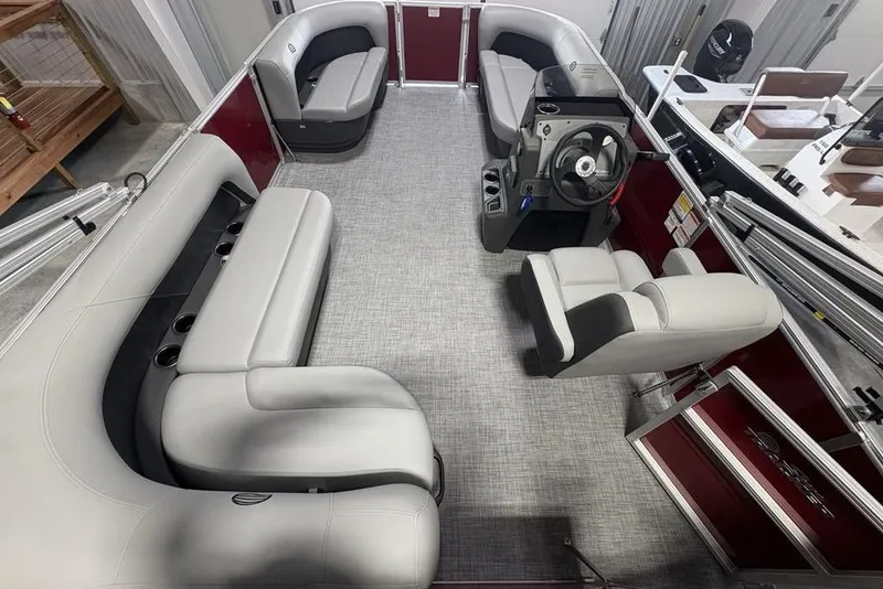 Slide: The Image of 2026 Sun Tracker Party Barge 16 DLX interior with plush seating and modern helm. - 20