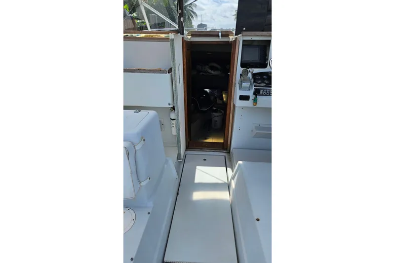 Slide: The Image of 1987 Rampage 28 Sportsman boat dashboard with steering wheel and navigation instruments. - 10
