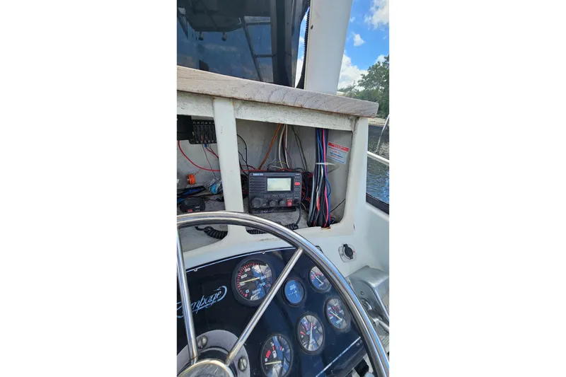 Slide: The Image of Garmin GPS device on 1987 Rampage 28 Sportsman boat dashboard. - 13