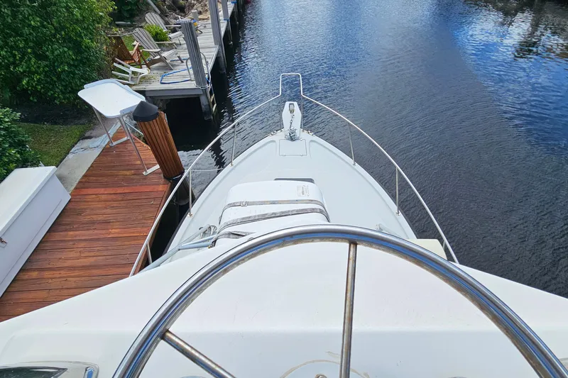 Slide: The Image of 1987 Rampage 28 Sportsman boat deck, docked by the water. - 17