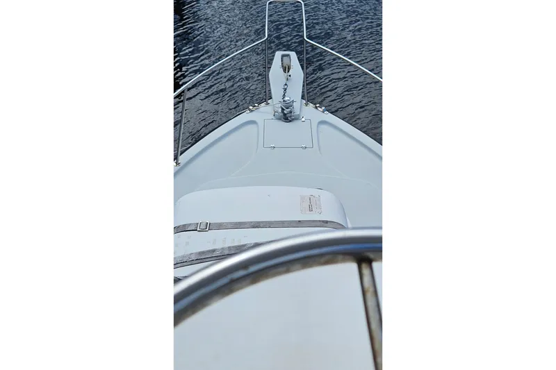 Slide: The Image of 1987 Rampage 28 Sportsman boat docked by wooden deck, viewed from helm. - 18